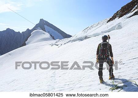 Mountaineer on a high climb on a long rope over a snowfield on the Altmann, Canton Valais, Switzerland, Europe View Large Photo Image Stock Photography - Mountaineer on a high climb on a long rope over a snowfield on the Altmann, Canton Valais, Switzerland, Europe. Fotosearch