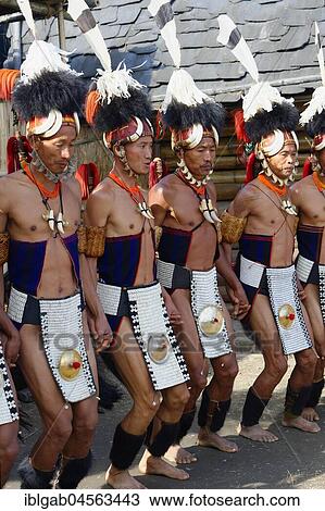 Stock Image - Naga tribal men in traditional clothing performing ritual dances, Kisima Nagaland Hornbill festival, Kohima, Nagaland, India, Asia. Fotosearch