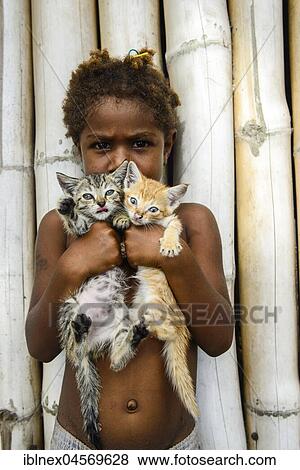 Native Child holds Two Little Cats, Ranon Beach Village, Island Ambryn, South Seas, Vanuatu, Oceania View Large Photo Image Stock Photo - Native Child holds Two Little Cats, Ranon Beach Village, Island Ambryn, South Seas, Vanuatu, Oceania. Fotosearch
