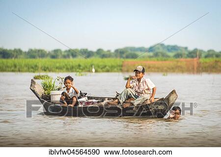 Native children wave on wooden boat, floating village, boat trip, Tonle Sap Lake, Cambodia, Southeast Asia, Asia View Large Photo Image Stock Image - Native children wave on wooden boat, floating village, boat trip, Tonle Sap Lake, Cambodia, Southeast Asia, Asia. Fotosearch