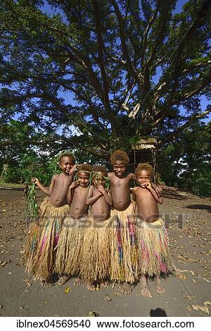 Stock Image - Native children with bast skirts, Yakeel Custom Village, Tanna Island, Vanuatu, South Seas, Oceania. Fotosearch