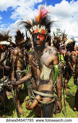 Stock Image - Native of the Highland tribes, Sandhown Warriors with peninsulas from Calebass gourds, Sing-Sing Festival, Goroka, Papua New Guinea, Oceania. Fotosearch