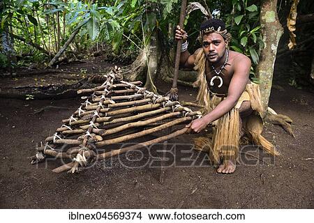 Picture - Native with built chicken trap, Ekasup Cultural Village, Island of Efate, Vanuatu, South Sea, Oceania. Fotosearch