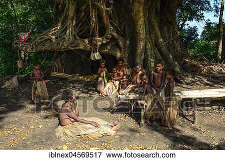 Stock Photo - Native women and children sitting together, Yakeel Custom Village, Tanna Island, Vanuatu, South Sea, Oceania. Fotosearch