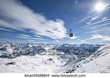 Nebelhorn cable car in front of snow-covered alpine panorama, Nebelhorn, Kleinwalsertal, Oberstdorf, Vorarlberg, Austria, Europe View Large Photo Image Picture - Nebelhorn cable car in front of snow-covered alpine panorama, Nebelhorn, Kleinwalsertal, Oberstdorf, Vorarlberg, Austria, Europe. Fotosearch