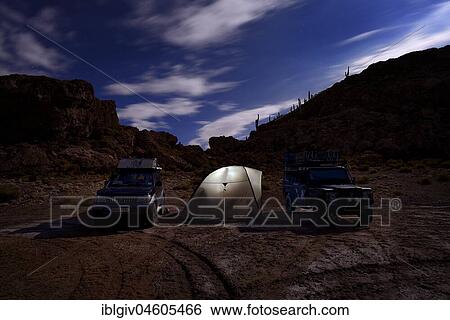 Stock Photograph - Night camp of two four-wheel drive vehicles, Isla Pescado, Salar de Uyuni, Uyuni, Potosi, Bolivia, South America. Fotosearch