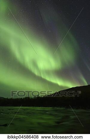 Stock Photo - Northern lights over the river Aisko in Abisko National Park, Sweden, Europe. Fotosearch