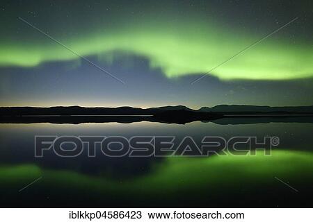 Stock Image - Northern lights reflected in a lake in the Abisko National Park, Sweden, Europe. Fotosearch