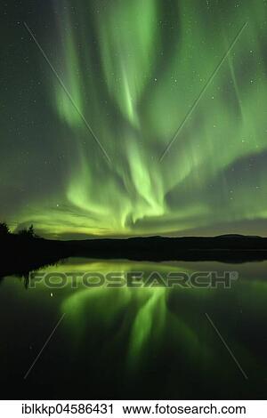Stock Image - Northern lights reflected in a lake in the Abisko National Park, Sweden, Europe. Fotosearch