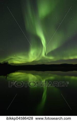 Stock Photo - Northern lights reflected in a lake in the Abisko National Park, Sweden, Europe. Fotosearch