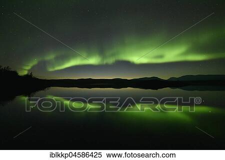 Stock Photography - Northern lights reflected in a lake in the Abisko National Park, Sweden, Europe. Fotosearch