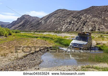 Off-road vehicle crosses Hoarusib River, Damaraland, Kunene Region, Namibia, Africa View Large Photo Image Picture - Off-road vehicle crosses Hoarusib River, Damaraland, Kunene Region, Namibia, Africa. Fotosearch