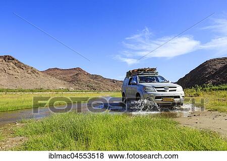Off-road vehicle crosses Hoarusib River, Damaraland, Kunene Region, Namibia, Africa View Large Photo Image Stock Photo - Off-road vehicle crosses Hoarusib River, Damaraland, Kunene Region, Namibia, Africa. Fotosearch