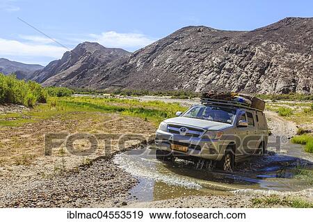 Off-road vehicle crosses Hoarusib River, Damaraland, Kunene Region, Namibia, Africa View Large Photo Image Stock Photo - Off-road vehicle crosses Hoarusib River, Damaraland, Kunene Region, Namibia, Africa. Fotosearch