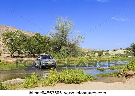 Off-road vehicle drives through Hoanib River, Khowarib Gorge, Damaraland, Kunene Region, Namibia, Africa View Large Photo Image Stock Photography - Off-road vehicle drives through Hoanib River, Khowarib Gorge, Damaraland, Kunene Region, Namibia, Africa. Fotosearch