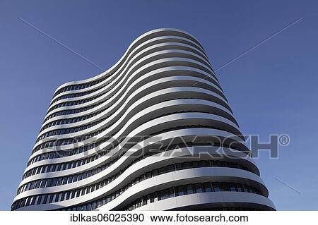 Stock Image - Office tower with curved facade by SOP Architekten, Trivago Campus, headquarters of the hotel search engine Trivago, Medienhafen Düsseldorf, North Rhine-Westphalia, Germany, Europe. Fotosearch