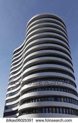 Stock Image - Office tower with curved facade by SOP Architekten, Trivago Campus, headquarters of the hotel search engine Trivago, Medienhafen Düsseldorf, North Rhine-Westphalia, Germany, Europe. Fotosearch