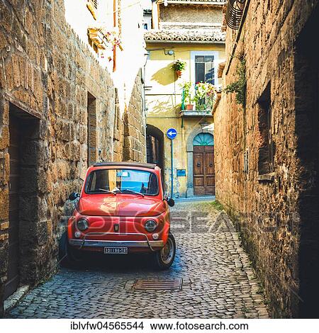 Picture - Old red Fiat 500 parked in a narrow alley, classic car, Orvieto, Umbria, Italy, Europe. Fotosearch