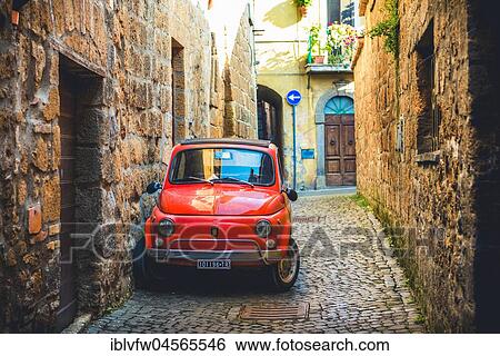 Stock Photograph - Old red Fiat 500 parked in a narrow alley, classic car, Orvieto, Umbria, Italy, Europe. Fotosearch