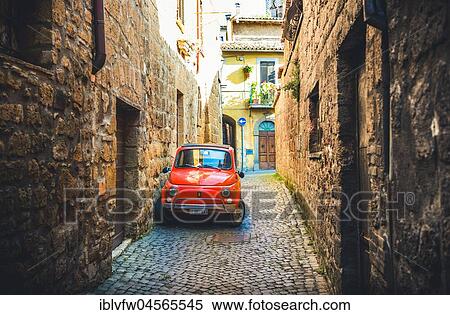 Stock Photography - Old red Fiat 500 parked in a narrow alley, classic car, Orvieto, Umbria, Italy, Europe. Fotosearch