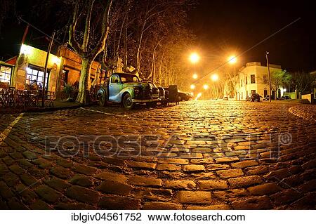 Oldtimer cars on cobblestone street, Avenida Gral Flores at night, Colonia del Sacramento, Uruguay, South America View Large Photo Image Stock Image - Oldtimer cars on cobblestone street, Avenida Gral Flores at night, Colonia del Sacramento, Uruguay, South America. Fotosearch