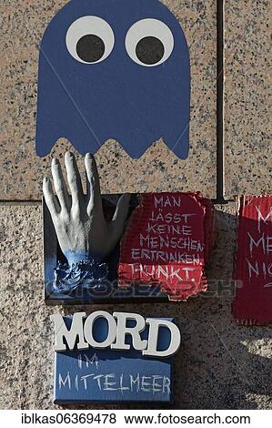 Outstretched hand and writing Murder in the Mediterranean Sea, Sea rescue of refugees, 3D art object on a wall, Open Air Gallery Flingern, Düsseldorf, North Rhine-Westphalia, Germany, Europe View Large Photo Image Stock Photo - Outstretched hand and writing Murder in the Mediterranean Sea, Sea rescue of refugees, 3D art object on a wall, Open Air Gallery Flingern, Düsseldorf, North Rhine-Westphalia, Germany, Europe. Fotosearch