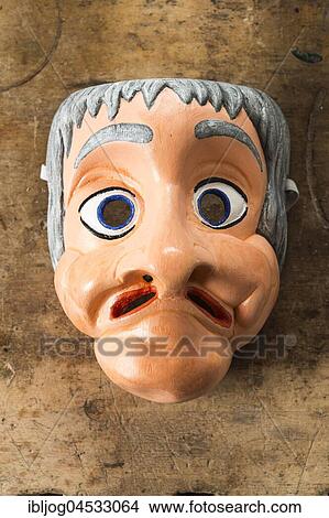 Picture - Painted wooden mask on a workbench, wooden mask carver, Bad Aussee, Styria, Austria, Europe. Fotosearch