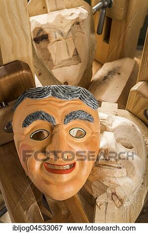 Stock Photo - Painted wooden mask on a workbench, wooden mask carver, Bad Aussee, Styria, Austria, Europe. Fotosearch