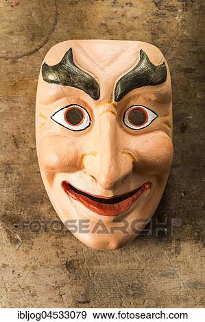 Stock Photo - Painted wooden mask on a workbench, wooden mask carver, Bad Aussee, Styria, Austria, Europe. Fotosearch