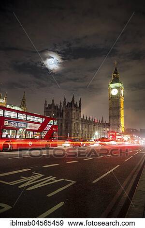 Stock Photo - Palace of Westminster with Big Ben at night, red double-decker bus on the Westminster Bridge, motion blur, London, England, Great Britain. Fotosearch