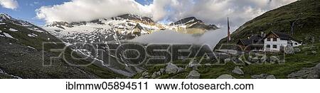 Stock Image - Panoramic view, Furtschaglhaus with mountains in clouds, mountain landscape in fog, Berliner Höhenweg, Zillertal Alps, Zillertal, Tyrol, Austria, Europe. Fotosearch