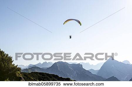 Stock Photography - Paragliding in flight in front of the Sonnjoch, Karwendel, Alpine panorama, Achensee, Tyrol, Austria, Europe. Fotosearch