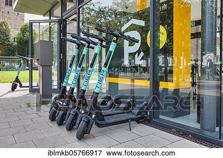 Stock Photo - Parked e-scooters of the company Tier in front of the entrance to a public parking garage, Düsseldorf, North Rhine-Westphalia, Germany, Europe. Fotosearch