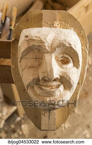 Stock Image - Partially shaped wooden block fixed on a workbench, unfinished wooden mask carver, wooden mask carver, Bad Aussee, Styria, Austria, Europe. Fotosearch
