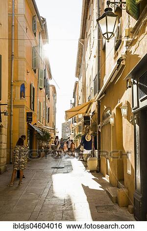 Stock Photograph - Pedestrians in alley, Old Town, St. Tropez, Var, Cote d' Azur, South of France, France, Europe. Fotosearch