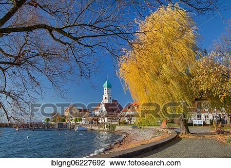 Stock Image - Peninsula with the parish church of St. George, moated castle on Lake Constance, Swabia, Bavaria, Germany, Europe. Fotosearch