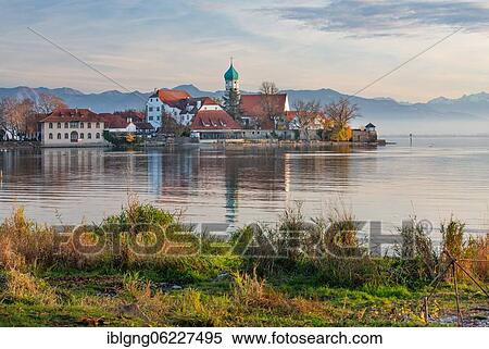 Peninsula with the parish church of St. George in front of the Alps in the evening sun, moated castle on Lake Constance, Swabia, Bavaria, Germany, Europe View Large Photo Image Stock Photography - Peninsula with the parish church of St. George in front of the Alps in the evening sun, moated castle on Lake Constance, Swabia, Bavaria, Germany, Europe. Fotosearch