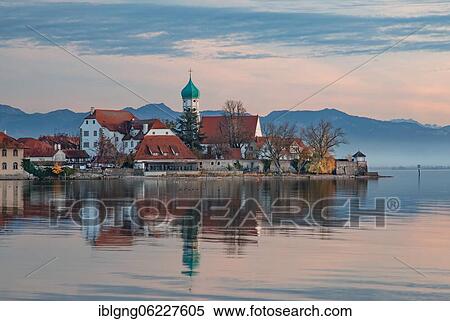 Peninsula with the parish church of St. George in front of the Alps in the evening sun, moated castle on Lake Constance, Swabia, Bavaria, Germany, Europe View Large Photo Image Stock Photography - Peninsula with the parish church of St. George in front of the Alps in the evening sun, moated castle on Lake Constance, Swabia, Bavaria, Germany, Europe. Fotosearch