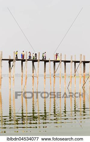 Stock Photo - People crossing U Bein bridge, Taungthaman Lake, Mandalay region, Myanmar, Asia. Fotosearch
