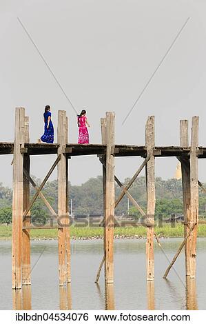 Stock Photograph - People crossing U Bein bridge, Taungthaman Lake, Mandalay region, Myanmar, Asia. Fotosearch