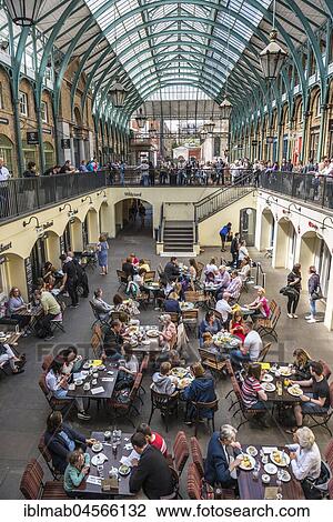Stock Image - People in the café, shopping mall Covent Garden, London, England, Great Britain. Fotosearch