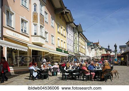 People sitting in café in front of row of historic houses, Marktstraße, Bad Tolz, Upper Bavaria, Bavaria, Germany, Europe View Large Photo Image Stock Photograph - People sitting in café in front of row of historic houses, Marktstraße, Bad Tolz, Upper Bavaria, Bavaria, Germany, Europe. Fotosearch