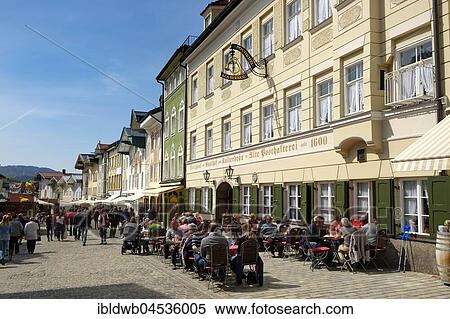 People sitting in tavern in front of row of historic houses, Marktstraße, Bad Tolz, Upper Bavaria, Bavaria, Germany, Europe View Large Photo Image Stock Photography - People sitting in tavern in front of row of historic houses, Marktstraße, Bad Tolz, Upper Bavaria, Bavaria, Germany, Europe. Fotosearch