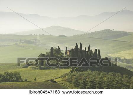 Stock Photo - Podere Belvedere, single homestead at sunrise with early fog, San Quirico d'Orcia, Val d'Orcia, Tuscany, Italy, Europe. Fotosearch