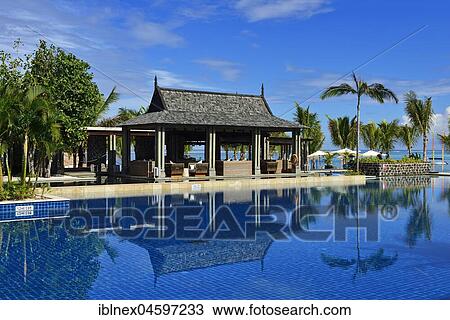 Stock Image - Pool with palm trees, Saint Regis Resort, Le Morne Brabant Peninsula, Mauritius, Indian Ocean, Africa. Fotosearch