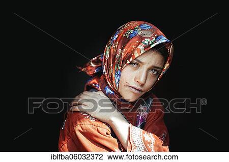 Stock Image - Portrait Sadaf Ma, child of a Wakhi family with traditional traditional traditional traditional traditional traditional traditional traditional traditional traditional costume of red cloth, who live as farmers and shepherds in Saradh-e-Broghil, Wakhan.... Fotosearch