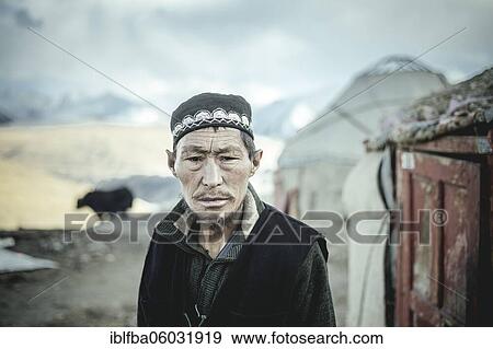 Stock Photo - Portrait village headman, Kyrgyz nomadic settlement, behind him a yak, a yurt and the snow-covered peaks of the Hindu Kush, Khadz Goz, Wakhan Corridor, Badakhshan, Afghanistan, Asia. Fotosearch