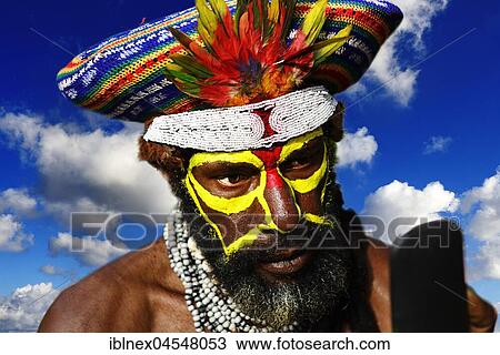 Stock Image - Preparing of the highland tribes, Hooks Ambe group, for the great yearly sing-sing of Goroka, Goroka, Papua New Guinea, Oceania. Fotosearch