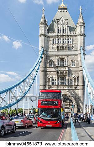 Stock Photo - Red double-decker bus crosses Tower Bridge, London, England, United Kingdom, Europe. Fotosearch