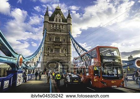 Stock Image - Red double-decker bus on the Tower Bridge, Southwark, London, England, United Kingdom, Europe. Fotosearch